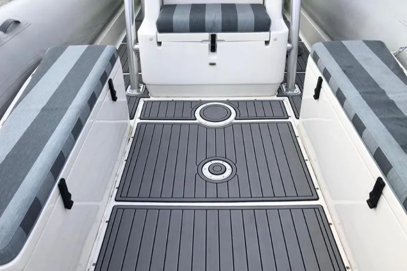 Slide: The Image of 2014 AB Inflatables Oceanus 28 VST interior with striped seating and sleek flooring. - 13