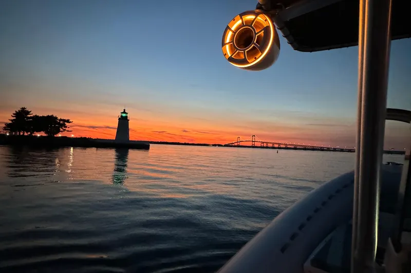 Slide: The Image of 2014 AB Inflatables Oceanus 28 VST at sunset near lighthouse and bridge. - 14