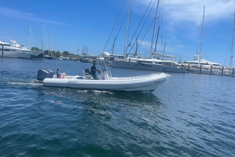 Slide: The Image of 2014 AB Inflatables Oceanus 28 VST boat cruising in a marina with yachts. - 15