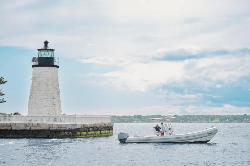 Slide: The Image of 2014 AB Inflatables Oceanus 28 VST near a lighthouse on a sunny day. - 16