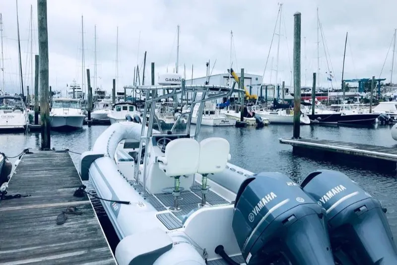 Slide: The Image of 2014 AB Inflatables Oceanus 28 VST docked at a marina with Yamaha engines. - 8