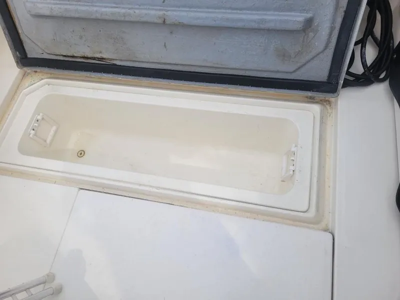 Slide: The Image of Open storage compartment on 1992 Sea Ray 310 Sport Bridge boat. - 29