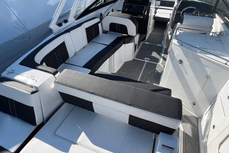 Slide: The Image of Luxurious seating on 2026 Monterey M-65 boat, featuring sleek black and white upholstery. - 12