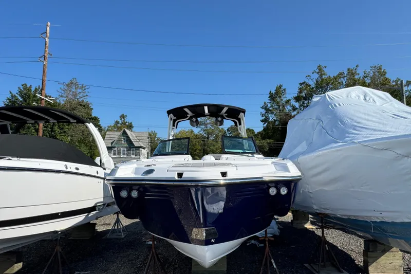 Slide: The Image of 2026 Monterey M-65 boat displayed outdoors, surrounded by other boats. - 4