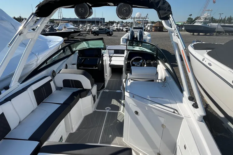 Slide: The Image of 2026 Monterey M-65 boat interior with sleek seating and modern design at a marina. - 7