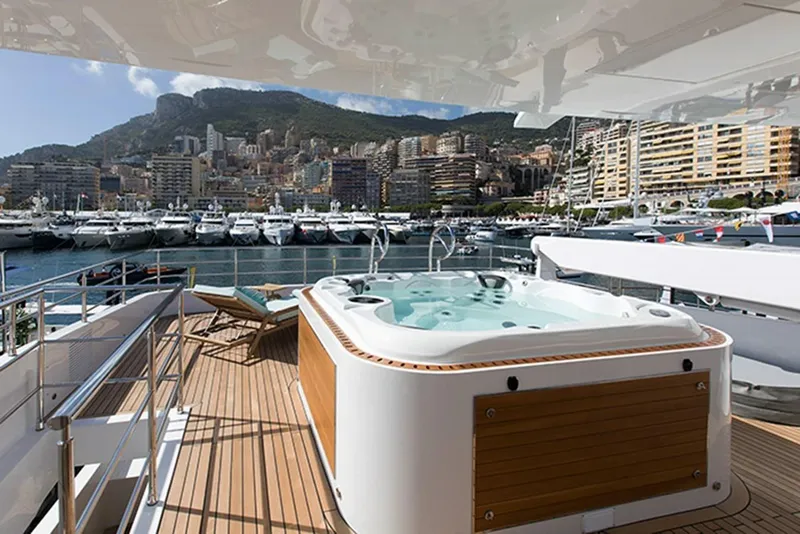 Slide: The Image of Luxury yacht Majesty 140 with jacuzzi, docked in a scenic marina, 2020 model. - 12