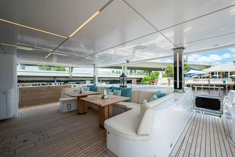 Slide: The Image of Luxurious 2020 Majesty 140 yacht deck with elegant seating and wooden flooring. - 23
