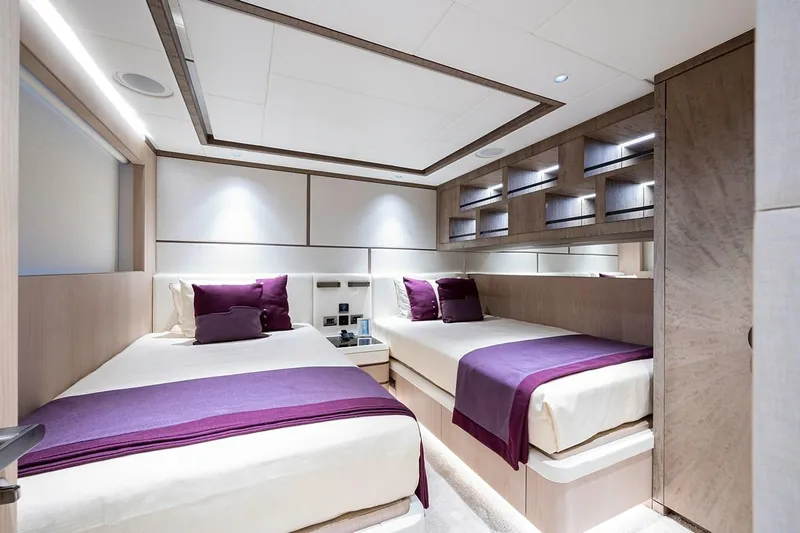 Slide: The Image of Luxurious twin bedroom on 2020 Majesty 140 yacht with modern decor and purple accents. - 48