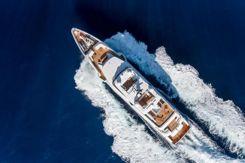 Slide: The Image of Aerial view of 2020 Majesty 140 yacht cruising on blue ocean waters. - 6