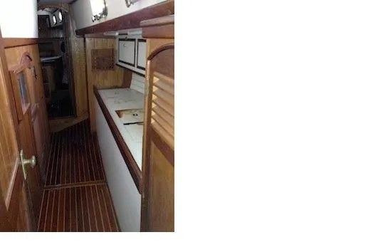 Slide: The Image of Port passageway to aft cabin featuring workshop area. - 19