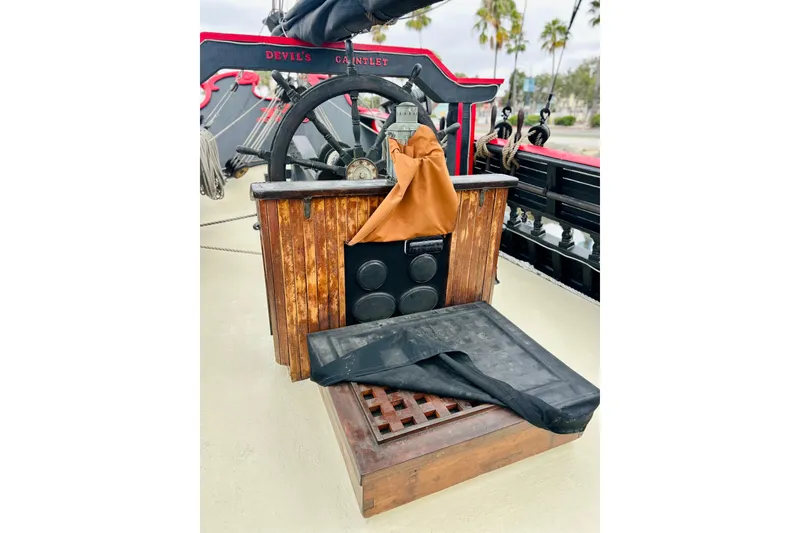 Slide: The Image of Wooden ship helm with wheel, labeled "Devil's Gauntlet," on 1977 Custom Brigantine. - 14