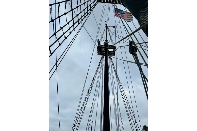 Slide: The Image of Tall ship mast with rigging and American flag, Custom Brigantine, 1977. - 16