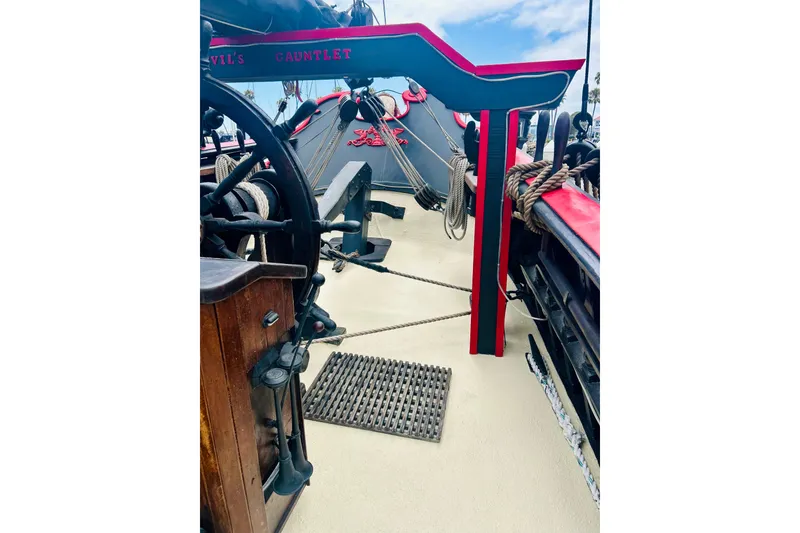 Slide: The Image of Vintage 1977 Custom Brigantine ship deck with wooden wheel and nautical ropes. - 24