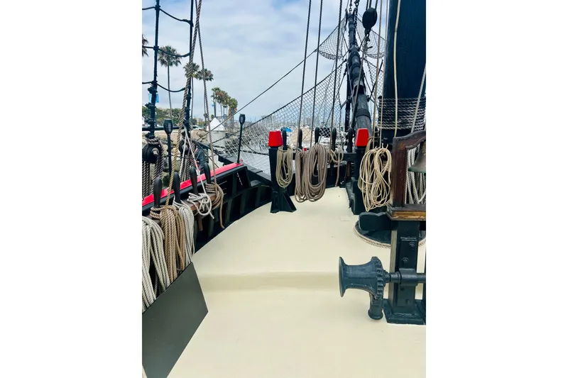 Slide: The Image of Deck view of a 1977 Custom Brigantine ship with ropes and rigging. - 27