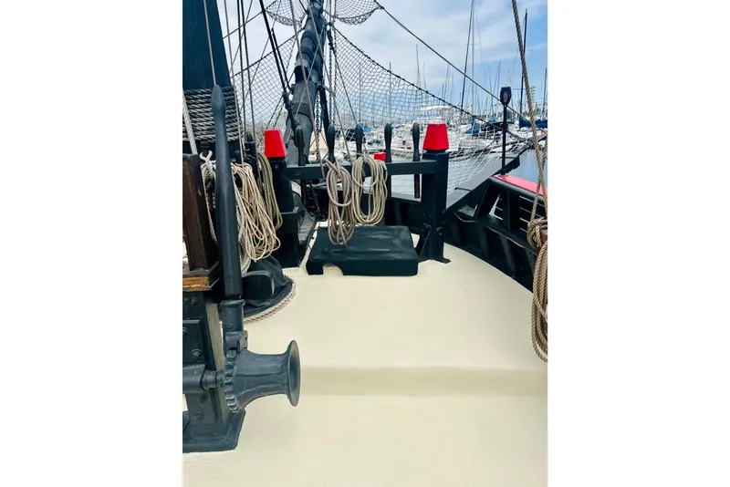 Slide: The Image of Deck of a 1977 Custom Brigantine ship with ropes and nautical equipment. - 28