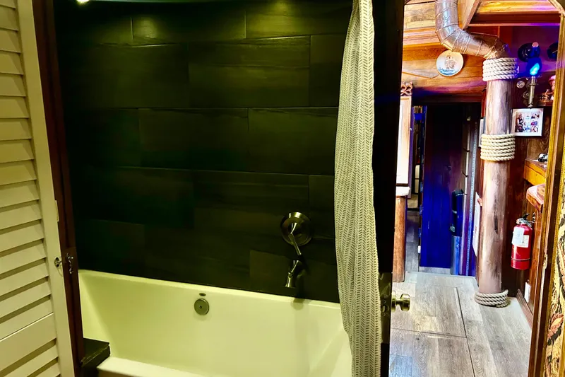 Slide: The Image of Luxurious bathroom on a 1977 Custom Brigantine yacht with modern fixtures and wooden interior. - 32
