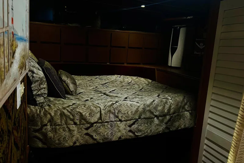 Slide: The Image of Cozy bedroom interior on a 1977 Custom Brigantine boat with patterned bedding. - 33