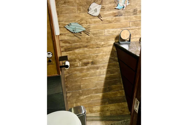 Slide: The Image of Wood-paneled bathroom with fish decor in a 1977 Custom Brigantine boat. - 34