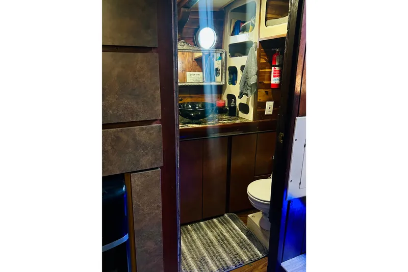 Slide: The Image of Interior of a 1977 Custom Brigantine boat bathroom with wooden accents and modern fixtures. - 36