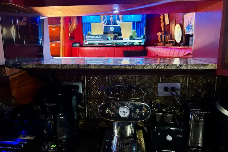 Slide: The Image of Cozy kitchen with coffee maker, granite countertop, and TV in a 1977 Custom Brigantine. - 38