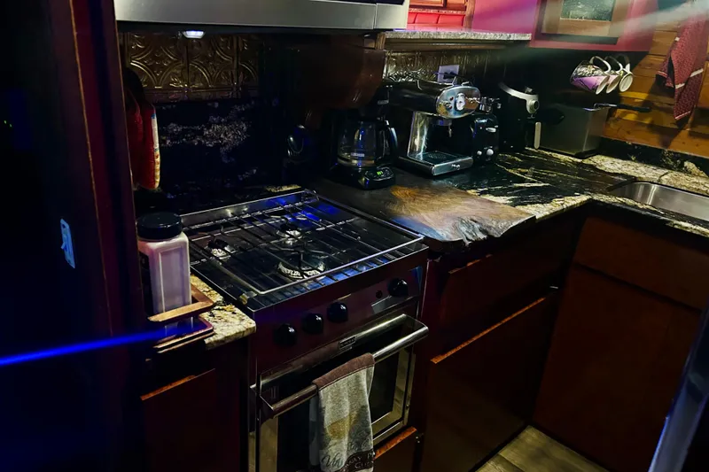 Slide: The Image of Cozy kitchen in a 1977 Custom Brigantine with stove, coffee maker, and granite countertops. - 39
