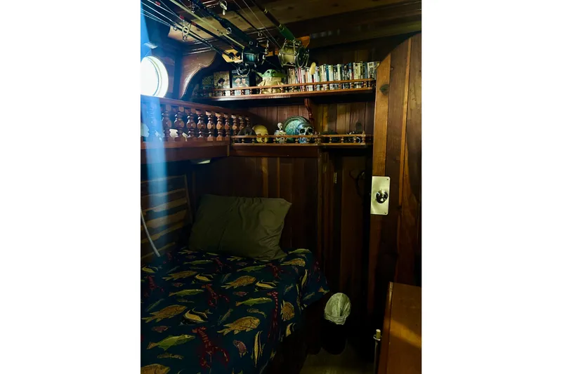 Slide: The Image of Cozy wooden cabin interior on a 1977 Custom Brigantine, featuring a bed and nautical decor. - 43