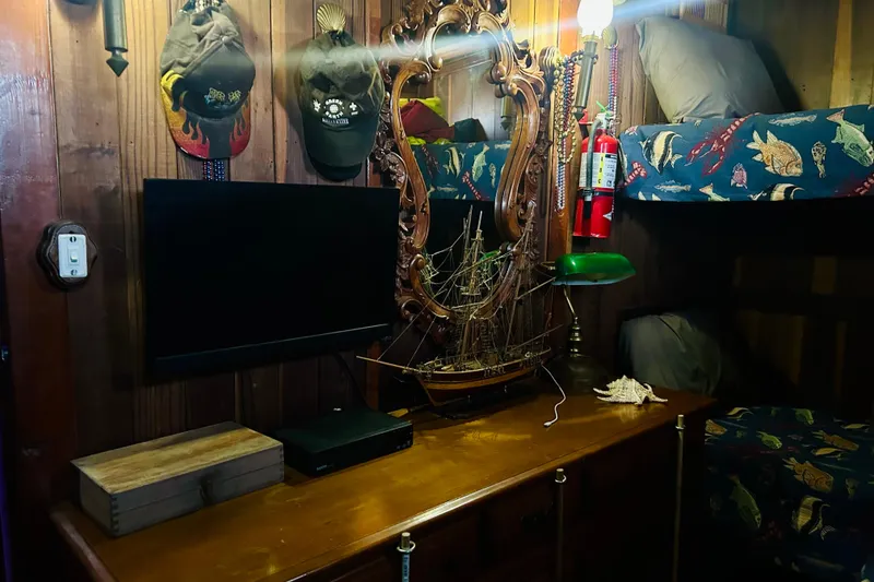 Slide: The Image of Cozy nautical-themed room with model ship, bunk beds, and vintage decor. - 44