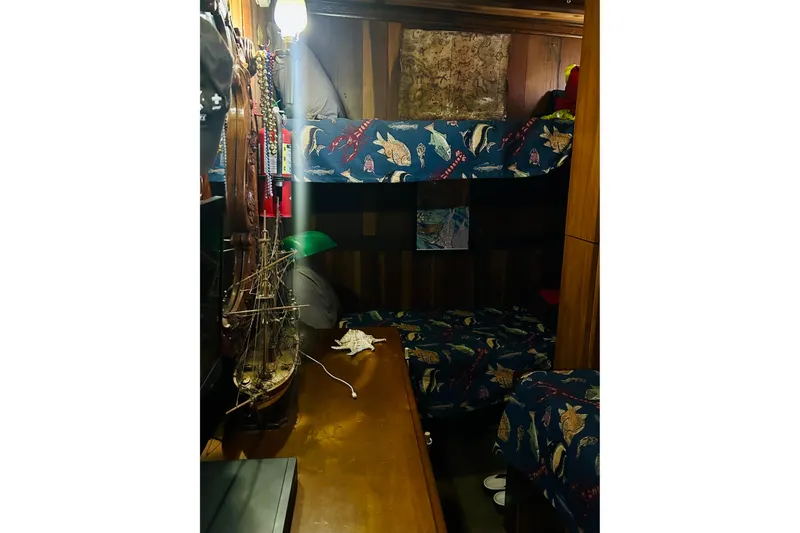 Slide: The Image of Cozy 1977 Custom Brigantine cabin with nautical-themed bunk beds and model ship decor. - 46