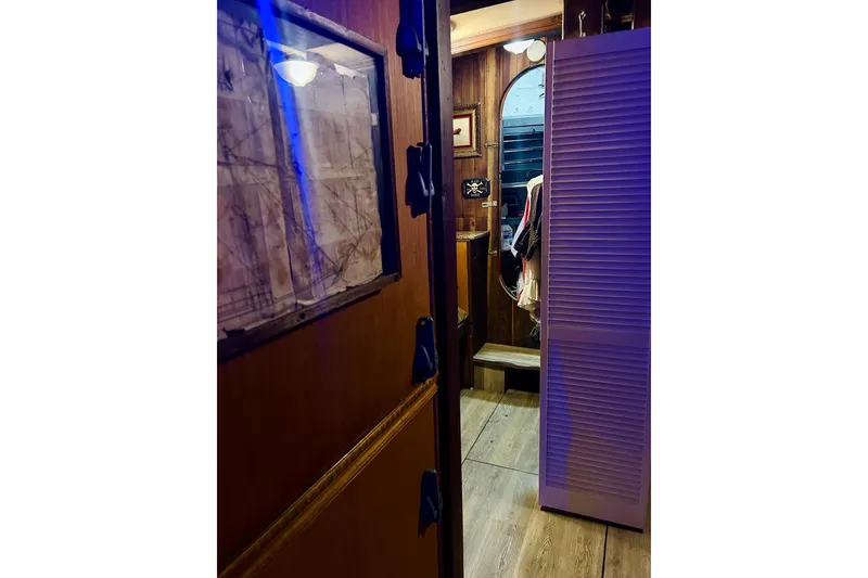 Slide: The Image of Interior of a 1977 Custom Brigantine with wooden decor and nautical elements. - 49