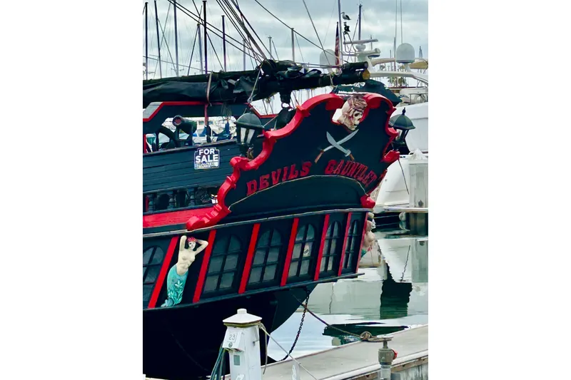 Slide: The Image of Vintage 1977 Custom Brigantine ship "Devil's Gauntlet" docked, featuring pirate-themed decor. - 5