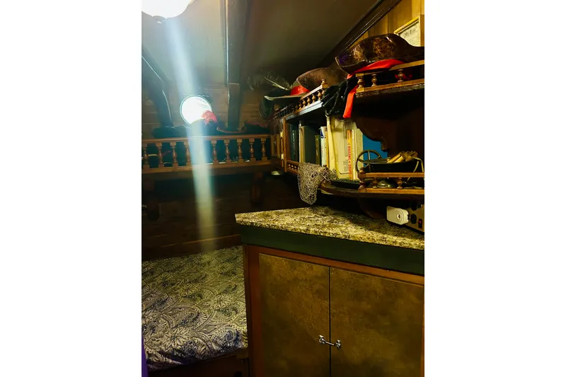Slide: The Image of Cozy 1977 Custom Brigantine cabin interior with books, porthole, and decorative shelves. - 53
