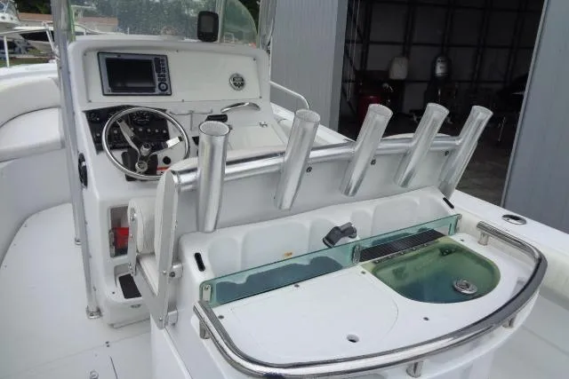 Slide: The Image of 2008 Triumph 235 CC boat interior with fishing rod holders and control panel. - 13