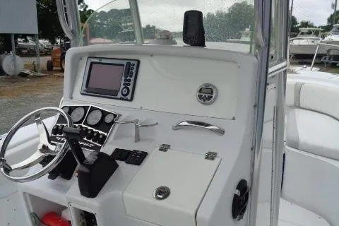 Slide: The Image of 2008 Triumph 235 CC boat dashboard with steering wheel and navigation system. - 16