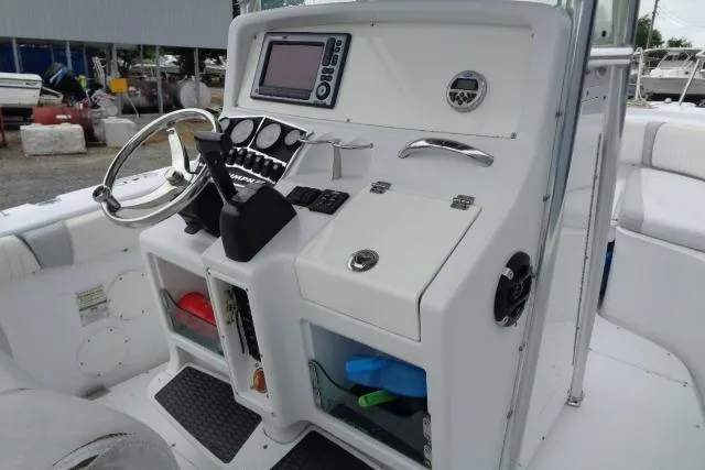 Slide: The Image of 2008 Triumph 235 CC boat console with steering wheel and navigation controls. - 17