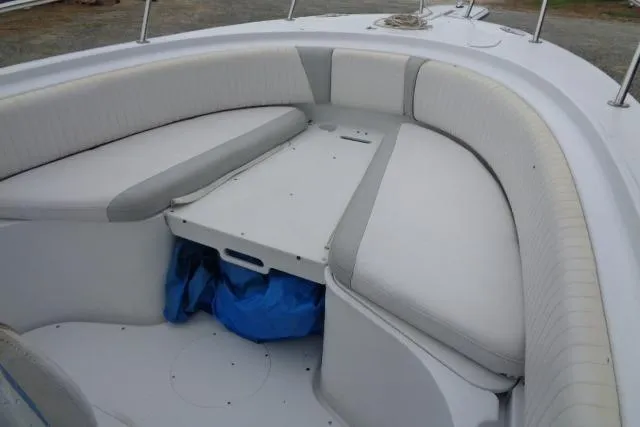 Slide: The Image of 2008 Triumph 235 CC boat interior with cushioned seating and storage area. - 18