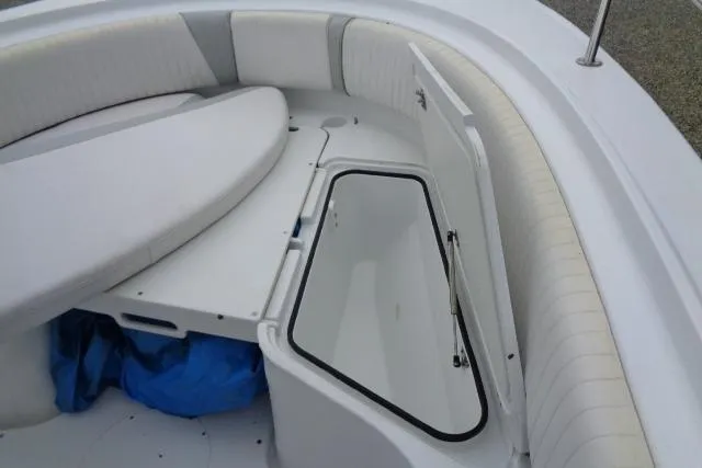Slide: The Image of 2008 Triumph 235 CC boat interior with open storage compartment and cushioned seating. - 19