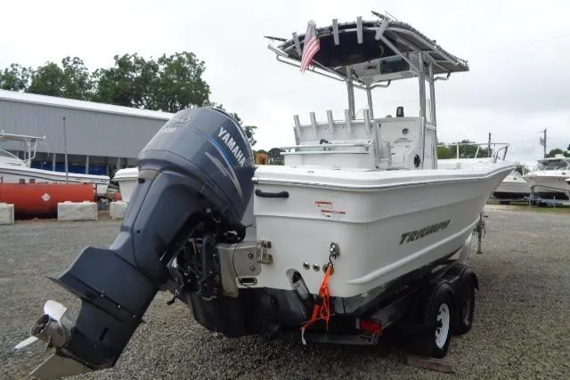 Slide: The Image of 2008 Triumph 235 CC boat with Yamaha outboard motor, parked on a trailer. - 2