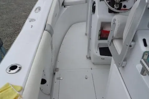Slide: The Image of 2008 Triumph 235 CC boat interior with white seating and steering console. - 21