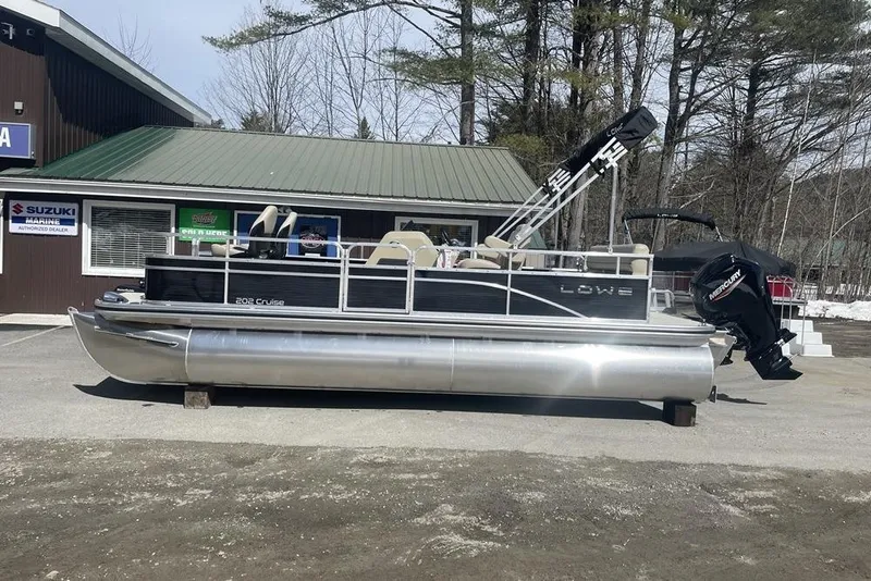 Slide: The Image of 2024 Lowe Ultra 202 Fish & Cruise pontoon boat parked outside dealership. - 1