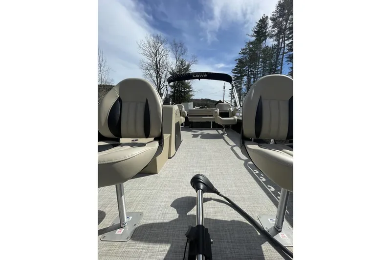 Slide: The Image of 2024 Lowe Ultra 202 Fish & Cruise pontoon boat interior with seating and canopy. - 10