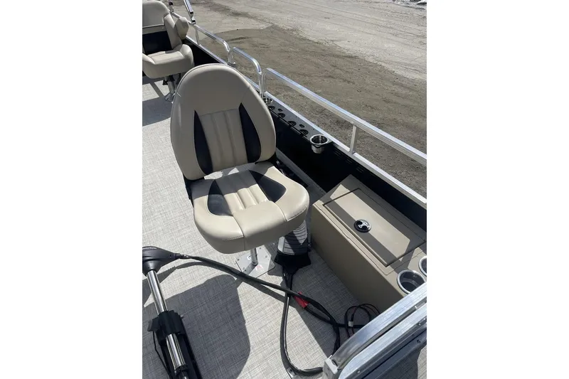 Slide: The Image of 2024 Lowe Ultra 202 Fish & Cruise boat interior with beige seating and storage. - 11