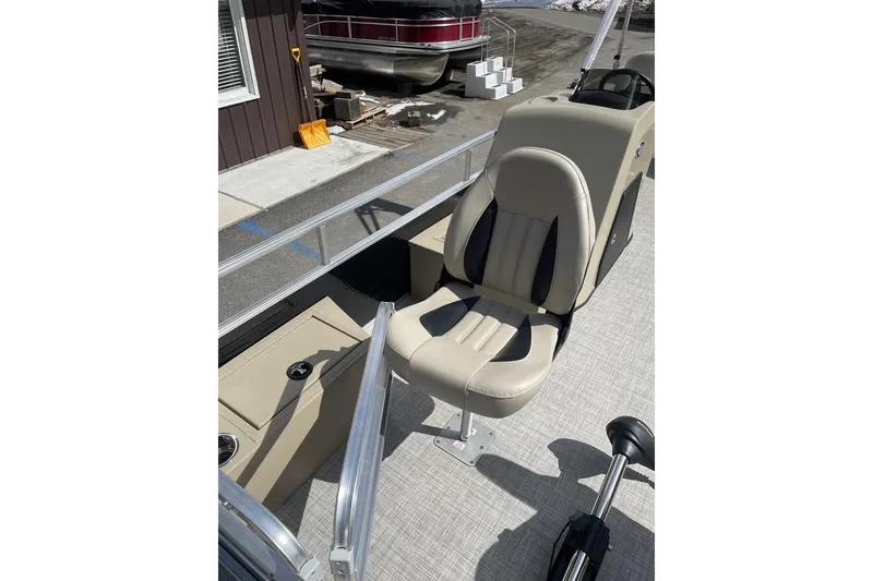 Slide: The Image of 2024 Lowe Ultra 202 Fish & Cruise boat interior with beige seating and console. - 12