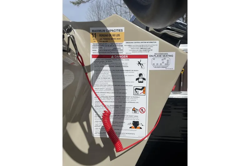 Slide: The Image of 2024 Lowe Ultra 202 Fish & Cruise capacity and safety warning label with red safety lanyard. - 15