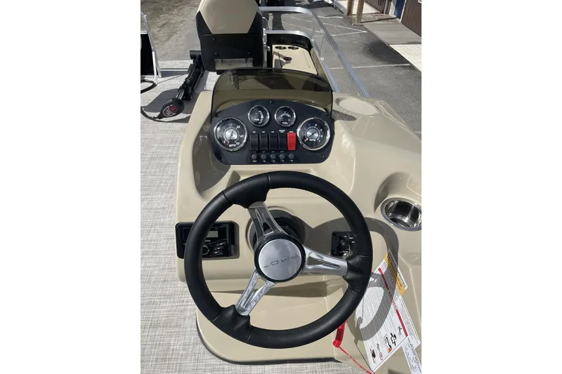 Slide: The Image of 2024 Lowe Ultra 202 Fish & Cruise boat dashboard with steering wheel and gauges. - 16