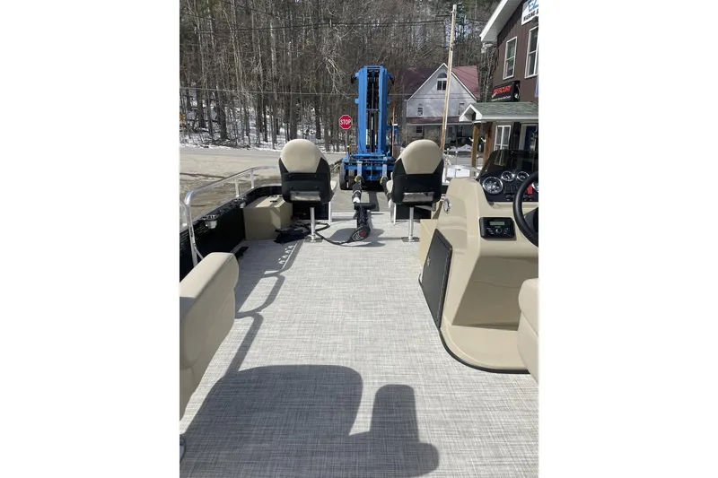 Slide: The Image of 2024 Lowe Ultra 202 Fish & Cruise pontoon boat interior with seating and control panel. - 21