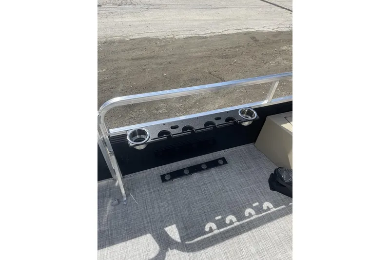 Slide: The Image of 2024 Lowe Ultra 202 Fish & Cruise boat interior with cup holders and railing. - 22