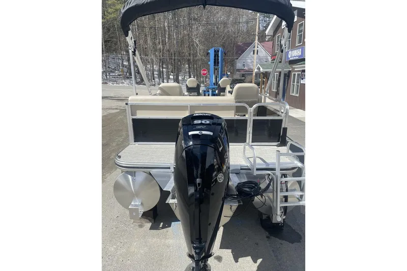 Slide: The Image of 2024 Lowe Ultra 202 Fish & Cruise pontoon boat with Mercury outboard motor, docked outdoors. - 5