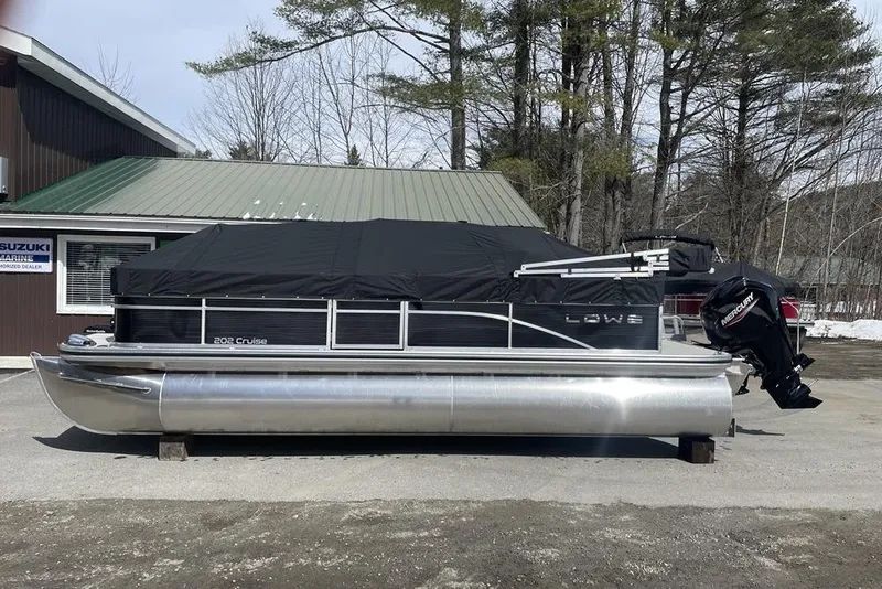 Slide: The Image of 2024 Lowe Ultra 202 Fish & Cruise pontoon boat with cover, parked outdoors. - 7