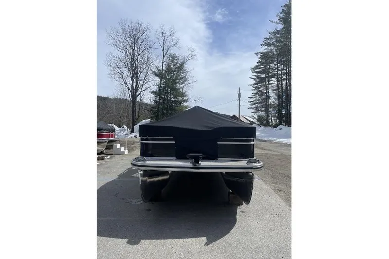 Slide: The Image of 2024 Lowe Ultra 202 Fish & Cruise pontoon boat with cover, parked outdoors. - 8