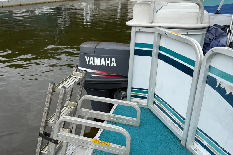 Slide: The Image of 1998 AquaPatio 210RS pontoon boat with Yamaha outboard motor and boarding ladder. - 10